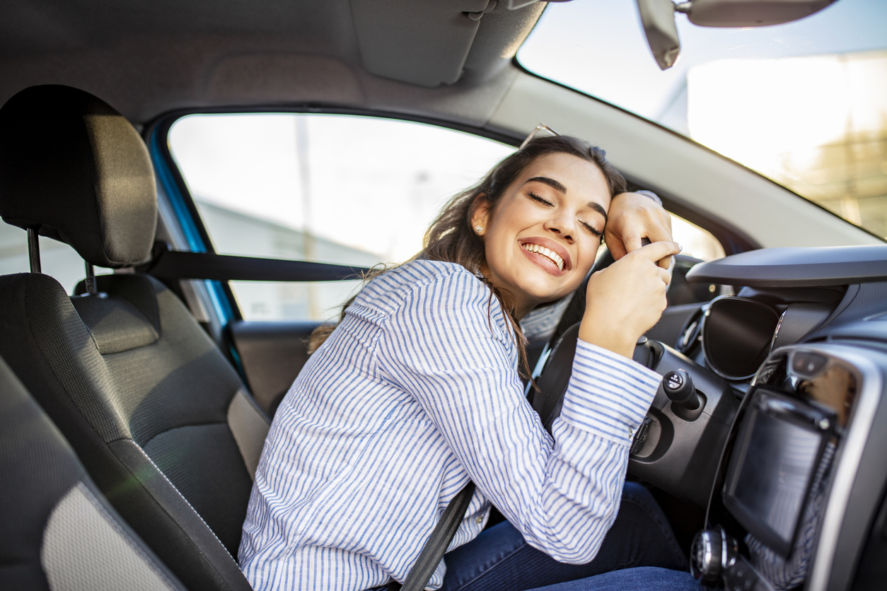 Man celebrating in car